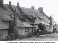 1930s view of the rear of Carnsew Cottages, showing their catslide roofs, dormers and wash-houses